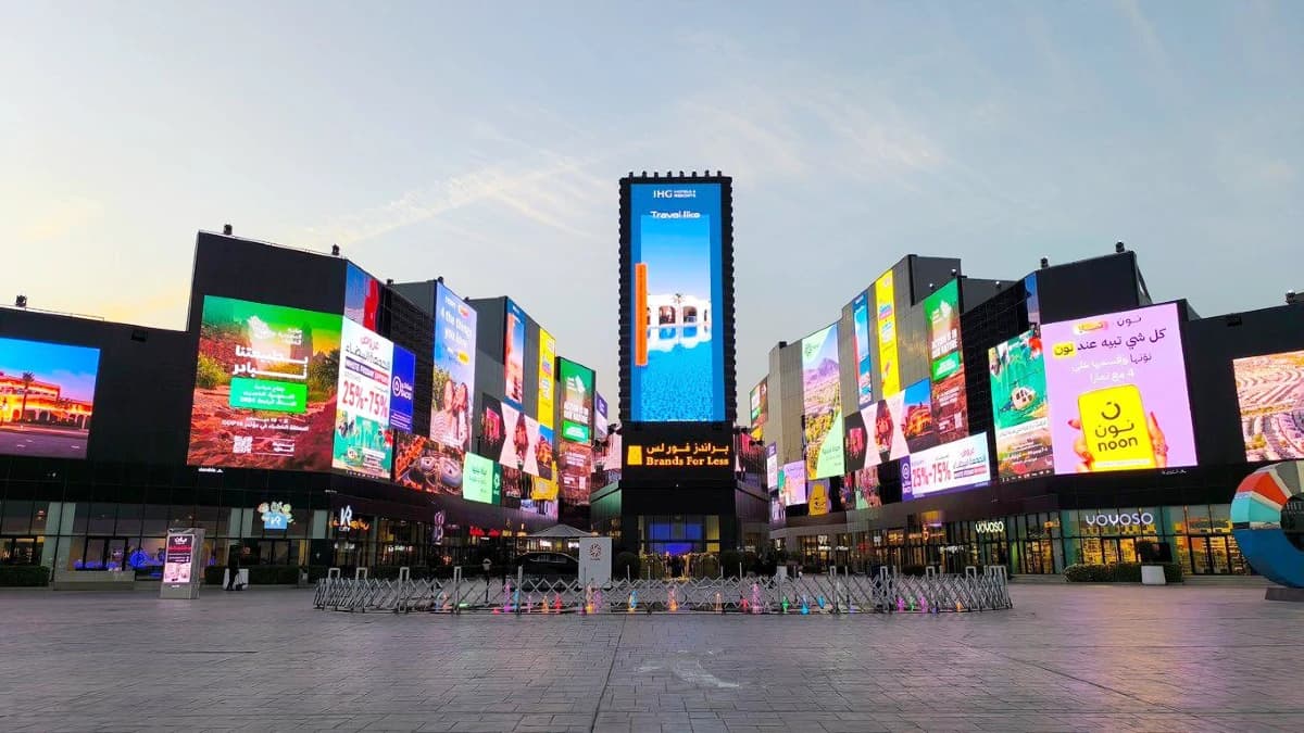 Boulevard City plaza at dusk with digital screens for IHG, noon, and White Friday