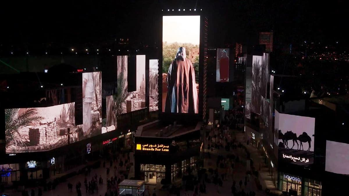 Boulevard City evening screens showing Saudi heritage imagery above Brands For Less